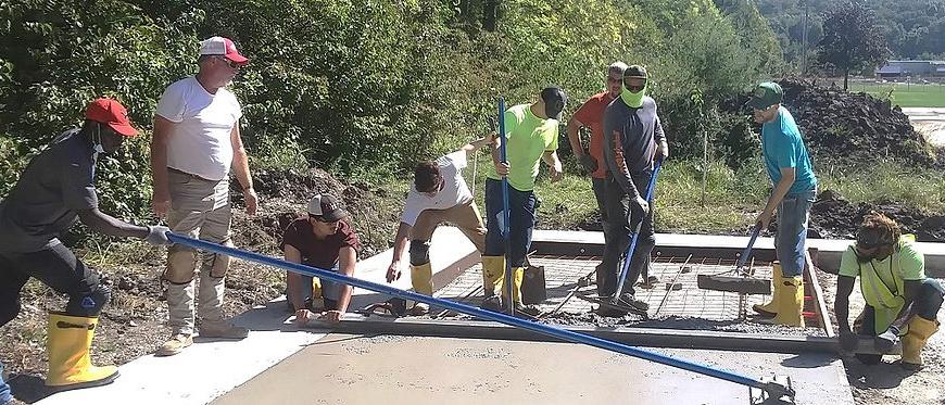 students pouring concrete