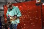 high school student welding with sparks flying