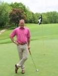 coach posing on golf course