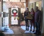 3 people standing in front of decorated door & 窗户