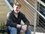 male student sitting on a staircase