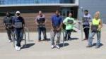 7 people lined up on sidewalk outside building