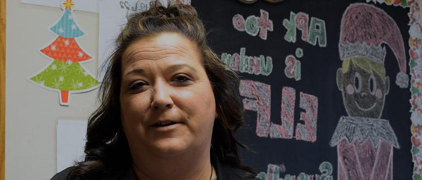 woman standing in front of chalkboard