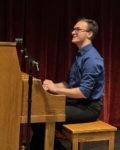 student playing upright piano