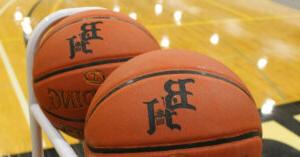 2 Basketballs in a Black Hawk Gymnasium