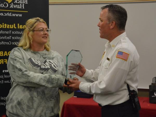 Deputy fire chief being handed award by BHC student