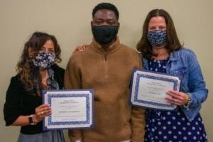 3 people wearing masks and holding certificates