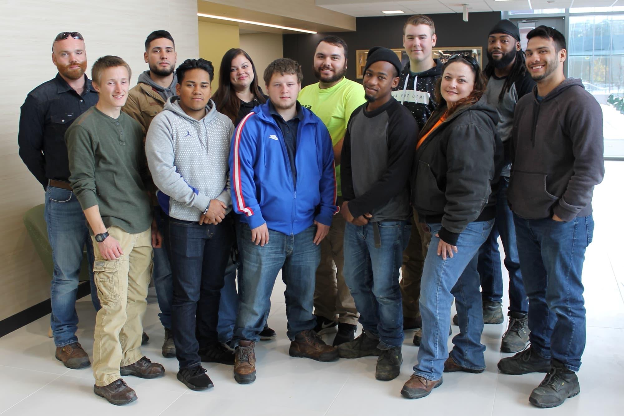 12 people lined up and looking at camera