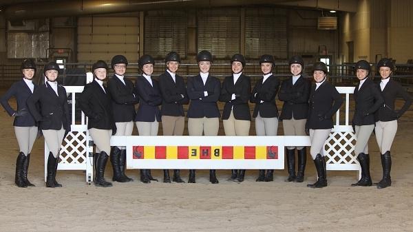 13 hunt seat riders standing in arena