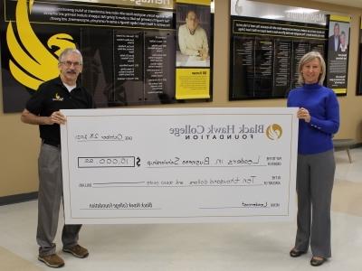 two people holding oversized check