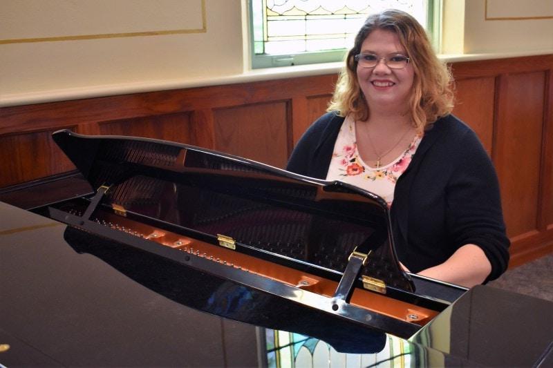 woman sitting at a piano